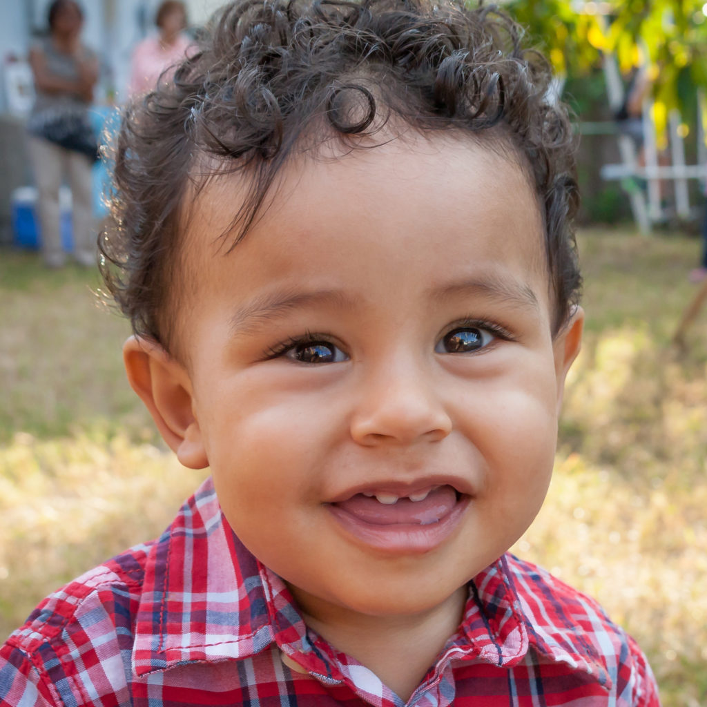 Happy one-year-old boy looking at the camera with a smile at a Preschool & Daycare Serving Greenville, AL