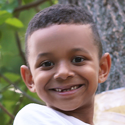 Little African-American boy climbing in adventure camp at a Preschool & Daycare Serving Greenville, AL
