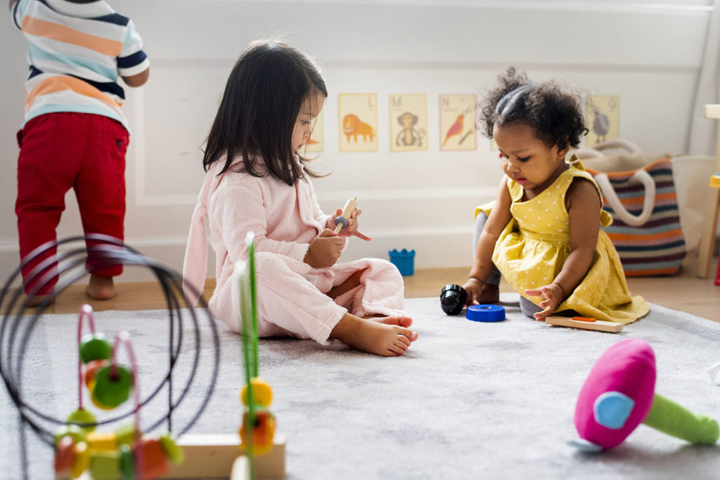 Little kids playing toys in the playroom at a Preschool & Daycare Serving Greenville, AL